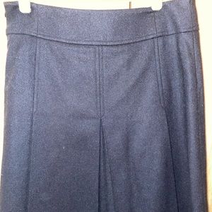 Black pleated, knee length wool skirt